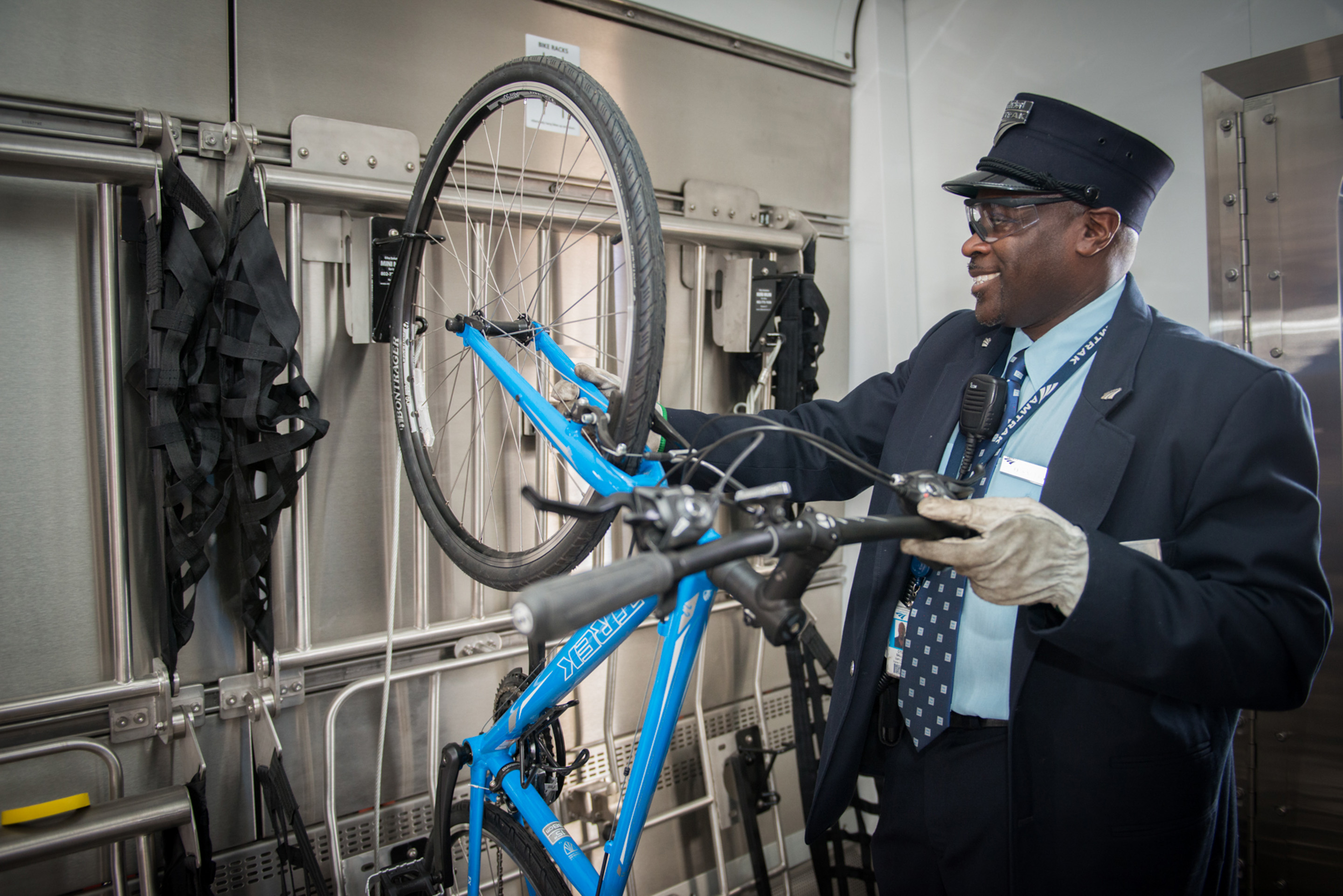 Station attendent placing a bicycle in a bike rack