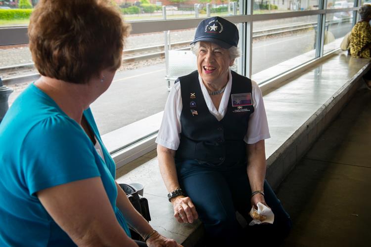 N.C. station host assisting passengers with questions and information